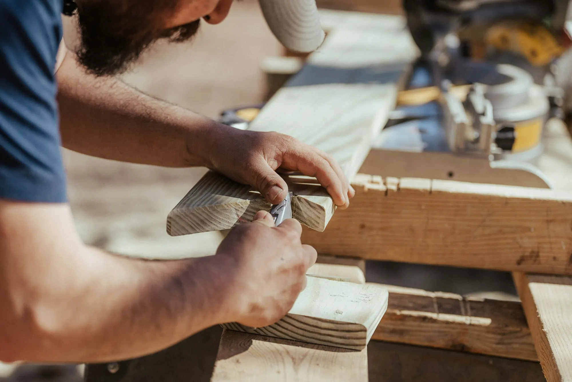 A carpenter's hands fitting a piece of wood on site